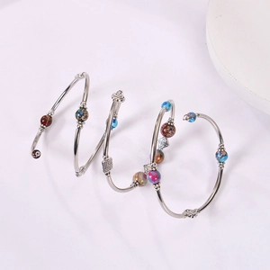 Detailed close-up of Bohemian wrap bracelet with layered emperor stone beads on silver wire