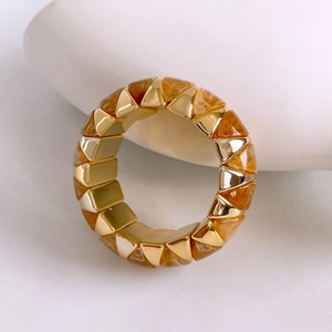 Macro shot of vintage style metal and amber resin modular bracelet in a sleek design