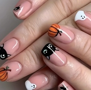 Detail of Halloween press-on nails featuring pumpkin, black cat, and ghost motifs