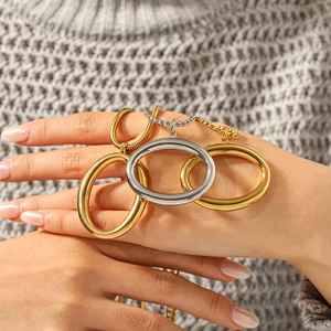 Polished stainless steel oval pendant necklaces in gold and silver on knit background