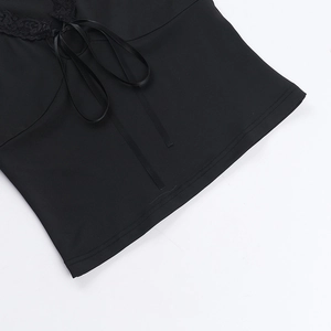 Detail of black lace trim and silky ribbon tie on a stylish street style knit top