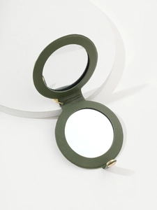 Close-up of a green PU leather portable makeup mirror with elegant gold metal snap button