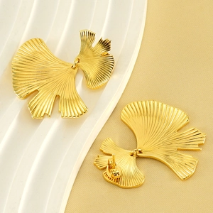 Fashionable gold ginkgo leaf earrings with layered metallic design and textured veins