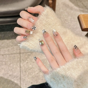 Handmade leopard press-on nails with amber gemstones and black heart dot patterns
