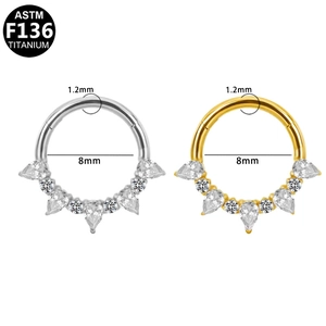 G23 titanium clicker rings in gold and silver finish with teardrop zircon stones