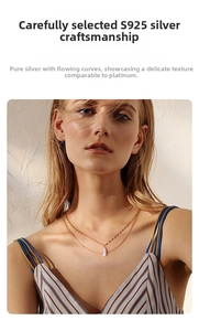Close-up of double-layer S925 sterling silver necklace with baroque pearl drop pendant