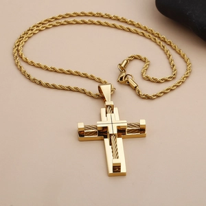 Detail shot of golden double-layered cross pendant with twisted wire design on steel chain