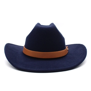 Detail of navy wool cowboy hat featuring a brown faux leather band and gold rivet