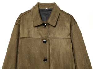 Detailed close-up of dark brown suede jacket featuring flap collar and shoulder texture