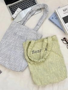 Chic checkered canvas tote bag with ruffled straps and embroidered logo for women