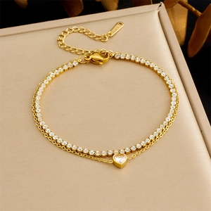 Detail of gold-plated double-layer stainless steel bracelet with heart-shaped zircon charms