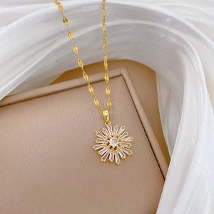 Close-up of titanium steel snowflake necklace with cubic zirconia on white silk