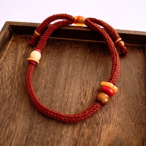Detailed view of handcrafted woven rope necklace with mixed agate and wooden beads