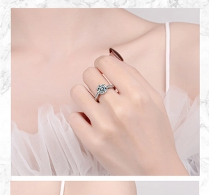 Close-up of model wearing silver ring featuring large clear gemstone and pavé accents