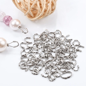 Macro view of silver U-shaped wire guards for jewelry beadwork on white background