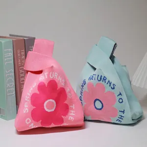 Floral knitted wedding gift bags in pink and blue with spring returns lettering