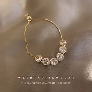 Adjustable gold plated bracelet featuring six sparkling square cut rhinestones on silk