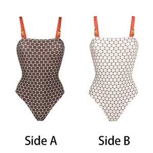 Polka dot reversible one-piece swimsuit with orange straps and bamboo buckle detail