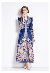 Detail of vintage V-neck maxi dress featuring intricate paisley patterns and ruffles