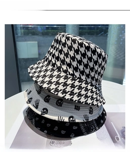 Detail showing stacked bucket hats with houndstooth, skull, and paisley print patterns