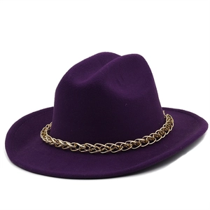 Close-up of a dark purple wool felt cowboy hat with a stylish gold chain band detail