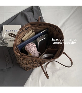 Spacious interior of leopard print tote bag with items showing large storage capacity