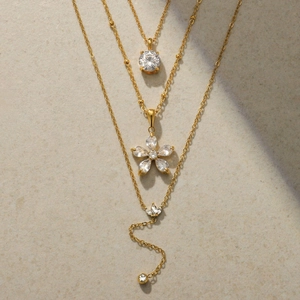 Three-layer gold titanium steel necklace featuring floral pendants and zircon accents
