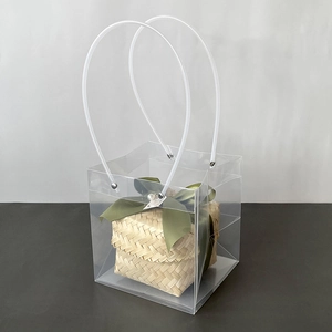 Transparent PVC gift bag with woven bamboo basket and elegant green ribbon detail
