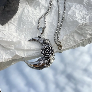 Gothic silver crescent moon necklace with rose pendant on a metal box chain