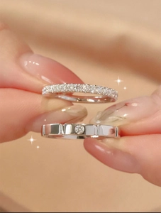 Macro shot of silver cube-style rings featuring pave diamonds and vertical line textures