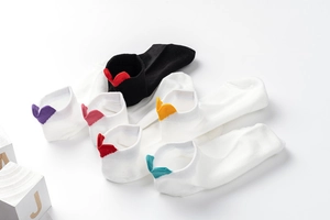 Close-up of low-cut cotton socks featuring colorful embroidered hearts on the heels