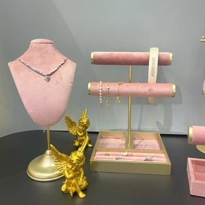 Luxury gold jewelry display stand with heart necklace, pearl bracelets and headbands