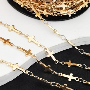 Detail view of golden metal cross chain roll for DIY jewelry making and necklaces