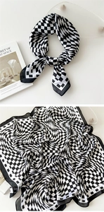 Detail of black and white distorted checkerboard silk scarf with elegant satin luster