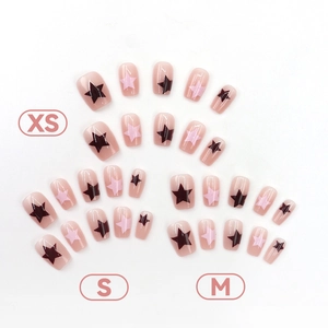 Short square nude pink press-on nails with black star patterns in XS S M sizes