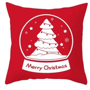 Close-up of red Christmas pillow case featuring a white snowy tree and Merry Christmas text