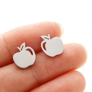 Detailed view of apple-shaped earrings showing polished finish and minimalist design