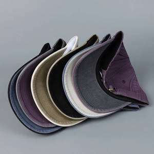Multiple colorful cotton baseball caps with curved brims and adjustable metal buckles