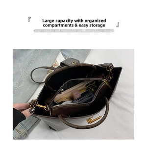 Macro detail of large brown leather tote with triple compartments and interior storage