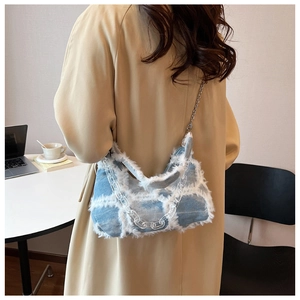 Detail of denim and faux fur shoulder bag with transparent acrylic chain strap