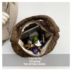 Top view of spacious brown quilted cloud bag showing interior room for tablet and daily items