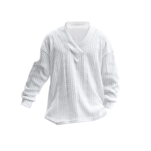 Detail of white V-neck cable knit sweater showing textured weave and premium fabric