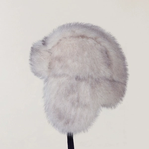 Detailed texture of grey faux fur winter trapper hat with fluffy gradient fibers