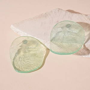 Detail of light green resin irregular drop charms with texture on stone base