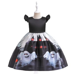 Detail of Halloween girls dress featuring pumpkin ghosts and spooky castle prints
