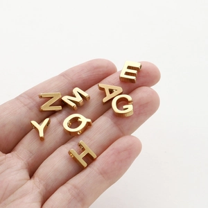 Gold plated 26 English letter beads for DIY jewelry making displayed on a white background