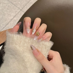 Handmade stiletto press-on nails with cat-eye effect and golden butterfly 3D charms