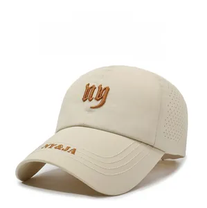Close-up of beige baseball cap with NY embroidery and laser-cut breathable side holes