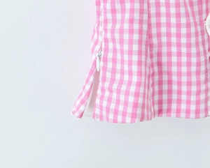 Detail view of pink and white checkered fabric with a hidden zipper closure
