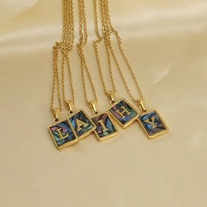 Golden stainless steel necklaces with rectangular shell alphabet pendants on silk